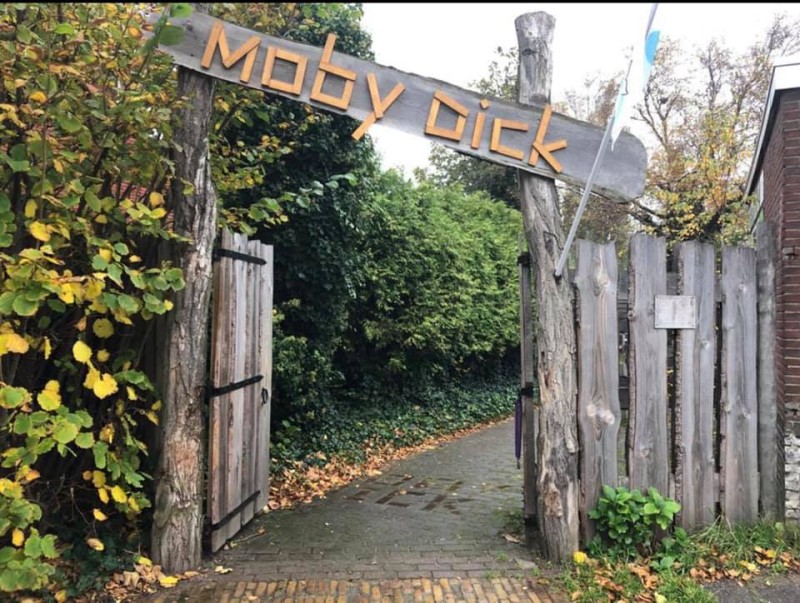 De sfeervolle houten brede ingang van speeltuin Moby Dick